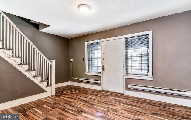 foyer entrance featuring wood-type flooring and a baseboard heating unit