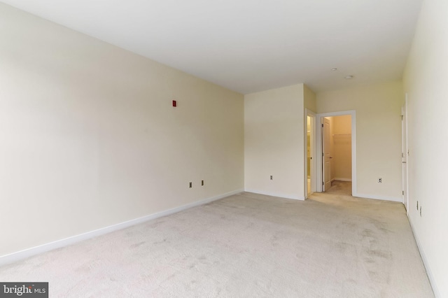 spare room with light colored carpet