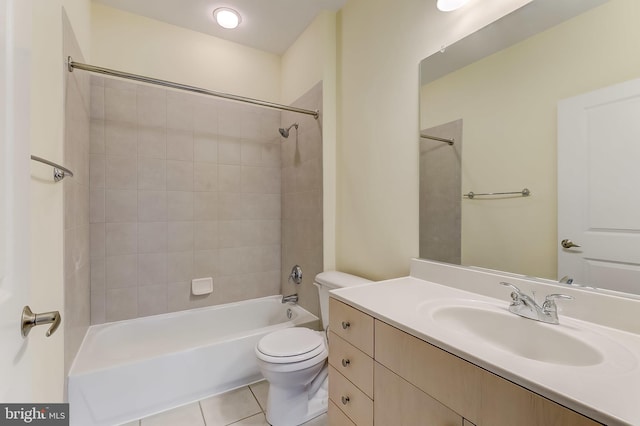 full bathroom featuring tile patterned flooring, vanity, toilet, and tiled shower / bath