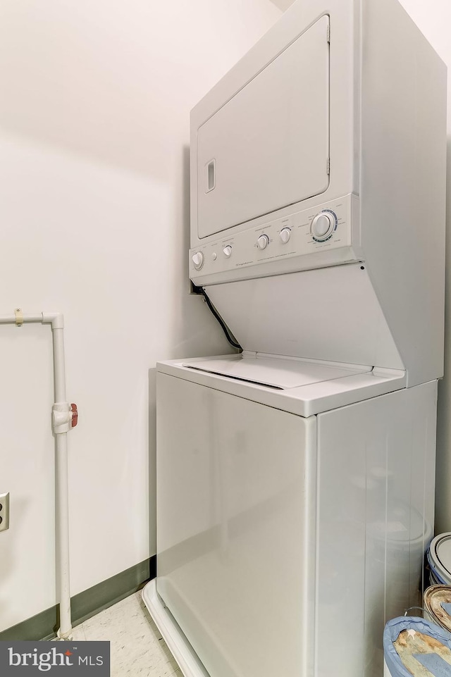 laundry room with stacked washer and clothes dryer