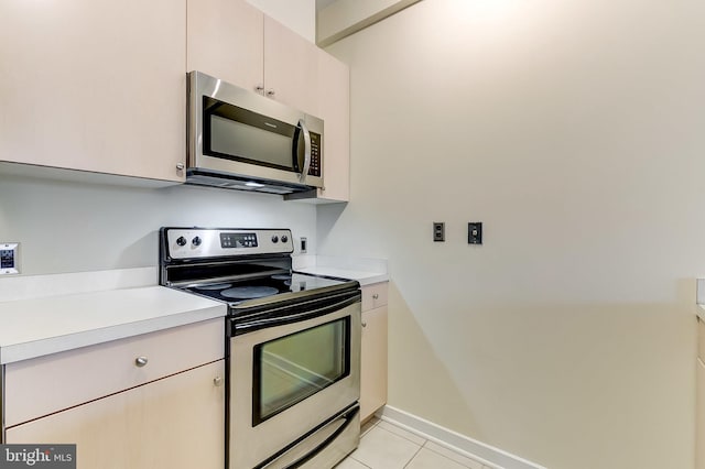 kitchen featuring appliances with stainless steel finishes and light tile patterned floors