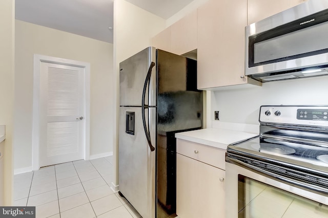 kitchen featuring light tile patterned floors and stainless steel appliances