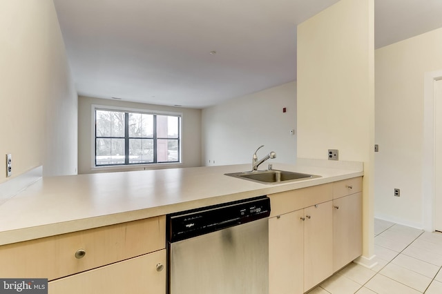 kitchen with dishwasher, kitchen peninsula, sink, and light tile patterned floors