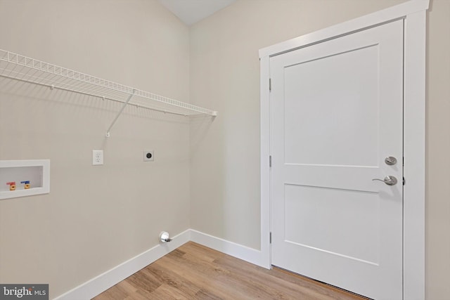 clothes washing area featuring hardwood / wood-style flooring, electric dryer hookup, and hookup for a washing machine