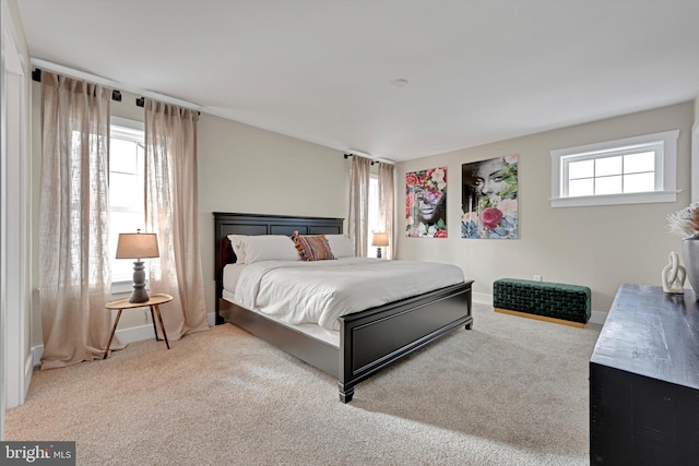 bedroom featuring carpet floors and multiple windows