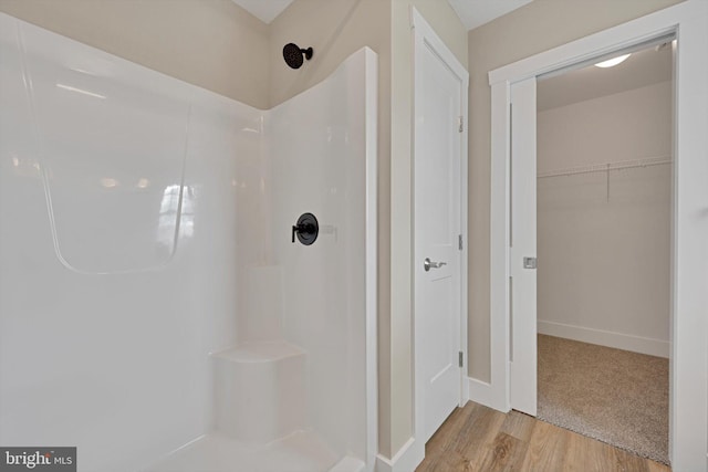 bathroom with hardwood / wood-style floors and walk in shower