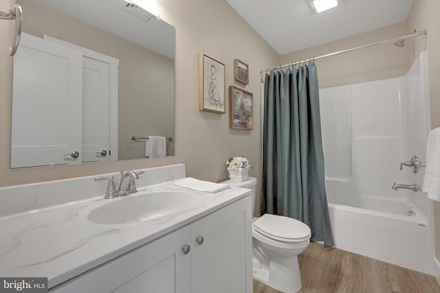 full bathroom with toilet, wood-type flooring, vanity, and shower / tub combo with curtain