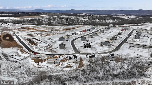 snowy aerial view with a mountain view