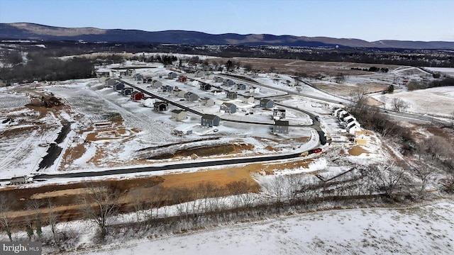 snowy aerial view featuring a mountain view