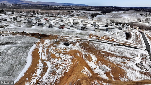 snowy aerial view featuring a mountain view