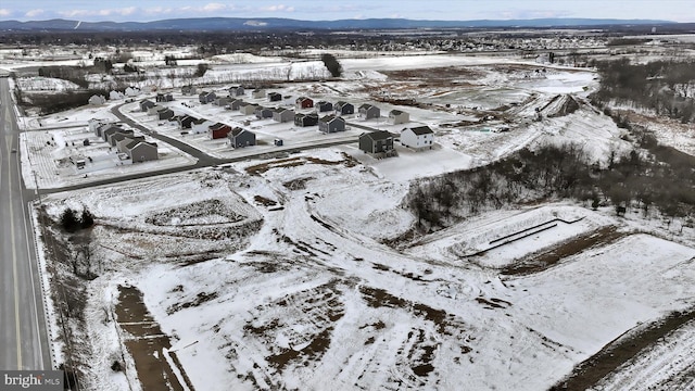 snowy aerial view with a mountain view