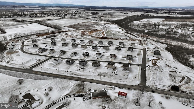 snowy aerial view with a mountain view