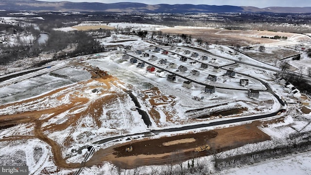 snowy aerial view featuring a mountain view