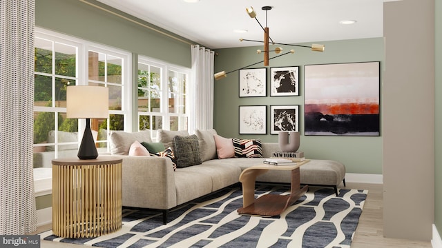 living area featuring baseboards, light wood finished floors, recessed lighting, and an inviting chandelier