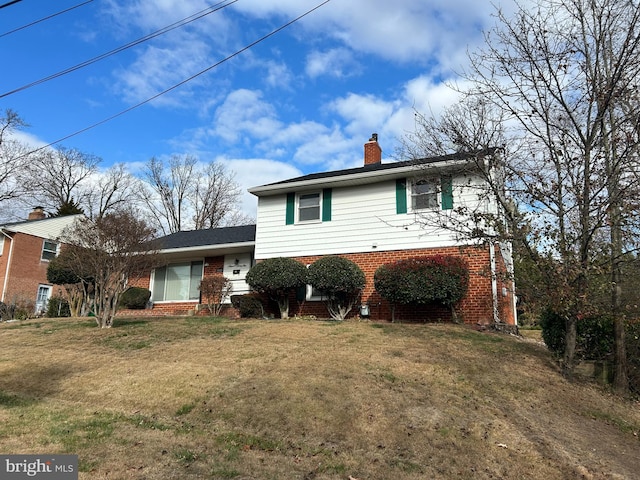 split level home featuring a front lawn