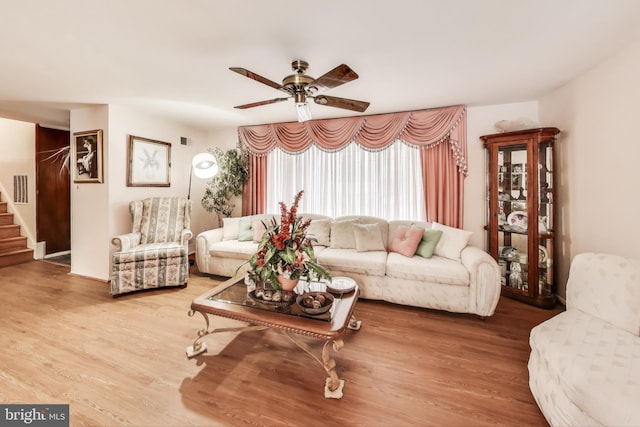 living room featuring ceiling fan and hardwood / wood-style floors