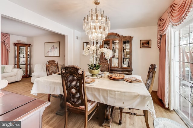 dining room featuring a chandelier and light hardwood / wood-style floors