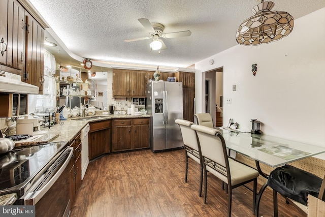 kitchen featuring appliances with stainless steel finishes, sink, a textured ceiling, and dark hardwood / wood-style floors