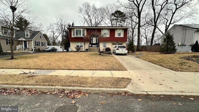 raised ranch featuring a front lawn