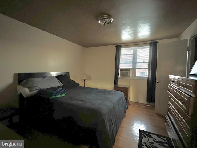 bedroom featuring cooling unit and light wood-type flooring