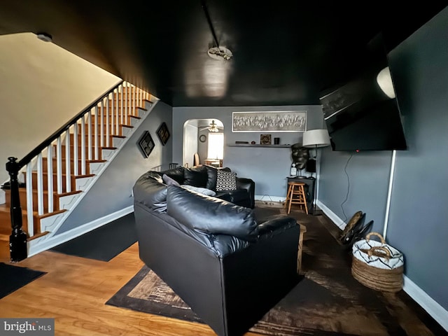 living room featuring ceiling fan and hardwood / wood-style floors