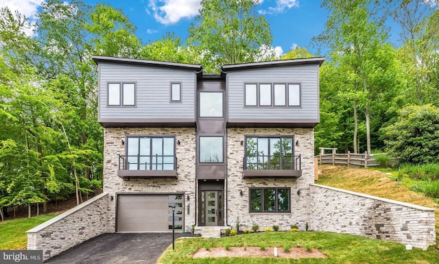 modern home featuring a garage and a front lawn