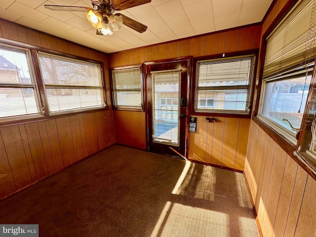 unfurnished sunroom with ceiling fan and plenty of natural light