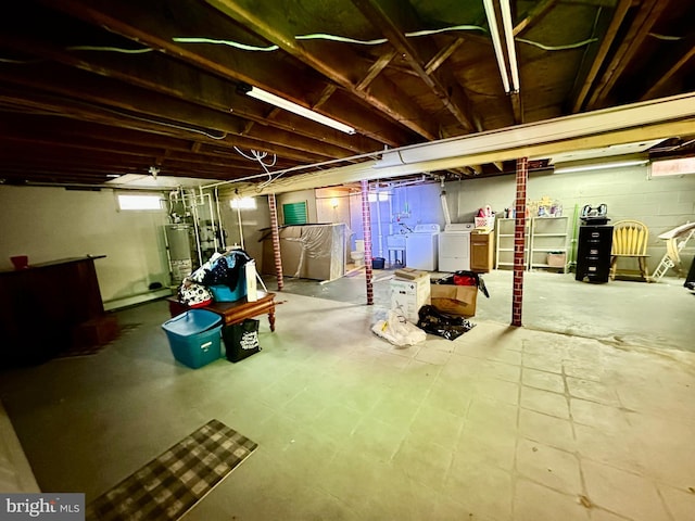 basement with washing machine and dryer and water heater