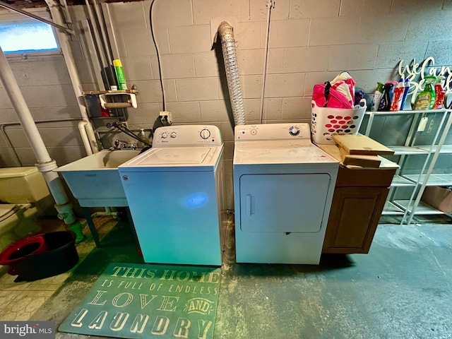 laundry area featuring washer and clothes dryer and sink