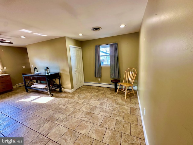 living area with ceiling fan and a baseboard radiator