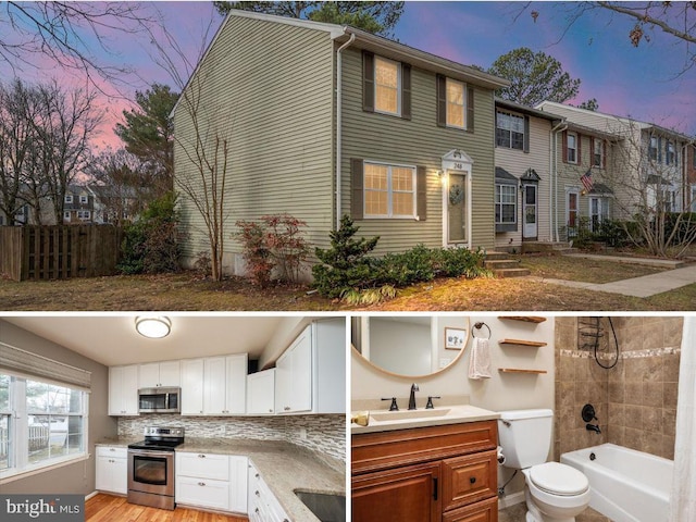 exterior space with appliances with stainless steel finishes, sink, white cabinets, and backsplash