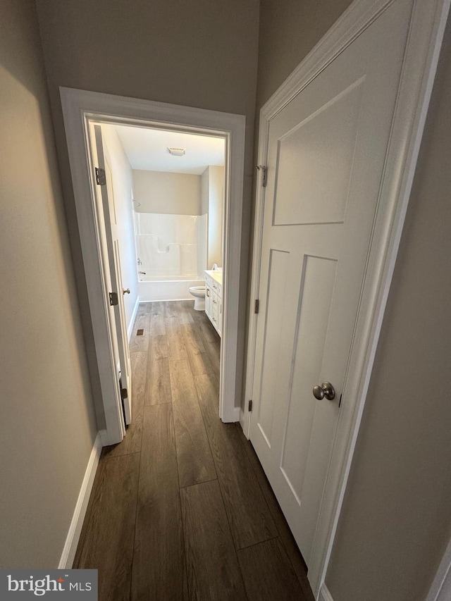 corridor featuring dark hardwood / wood-style floors