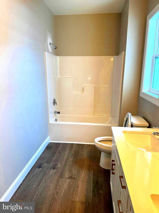 full bathroom featuring tub / shower combination, hardwood / wood-style floors, toilet, and vanity