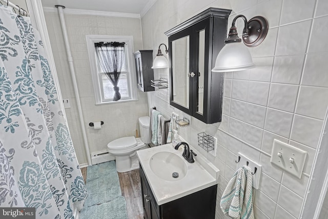 bathroom with vanity, a baseboard heating unit, crown molding, toilet, and tile walls