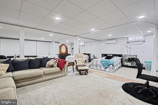 bedroom featuring a drop ceiling and an AC wall unit