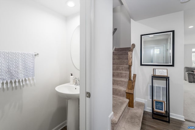 bathroom with hardwood / wood-style floors