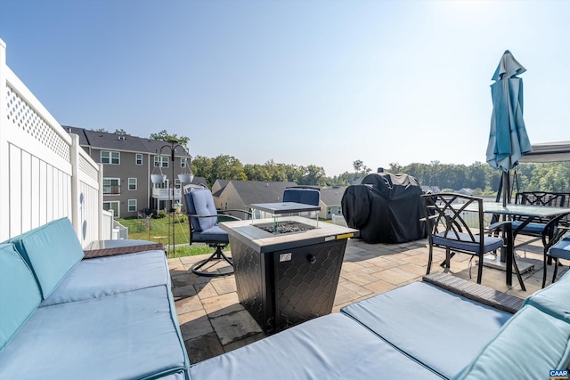 view of patio / terrace with a grill and an outdoor living space with a fire pit