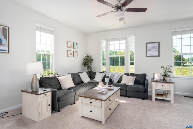 living room with ceiling fan and light colored carpet