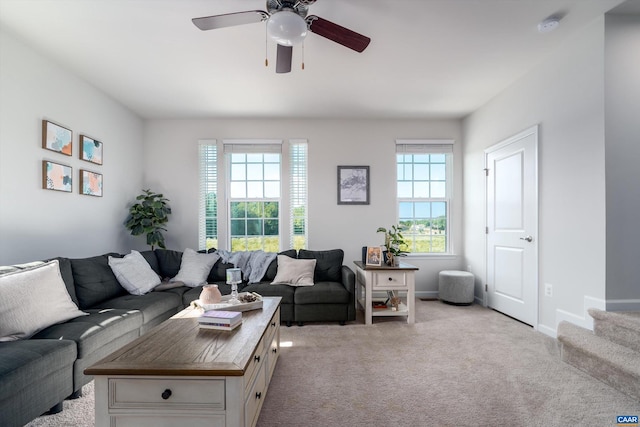 carpeted living room featuring ceiling fan and a healthy amount of sunlight