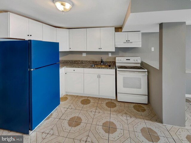 kitchen featuring sink, white electric range oven, black fridge, dark stone countertops, and white cabinets