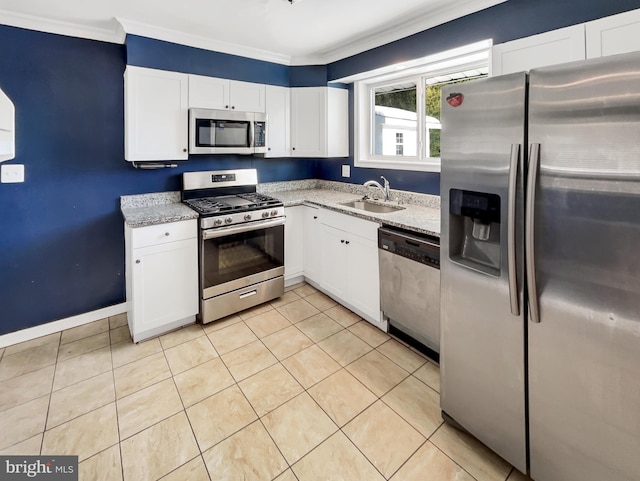 kitchen with white cabinets, sink, light tile patterned floors, appliances with stainless steel finishes, and light stone counters