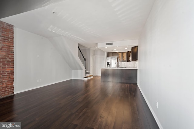 unfurnished living room featuring dark hardwood / wood-style flooring