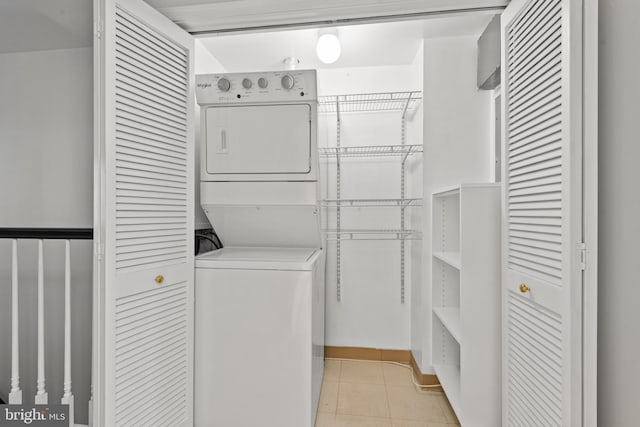 laundry room featuring stacked washer / drying machine