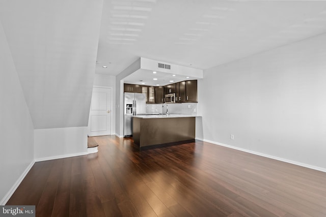 unfurnished living room featuring dark hardwood / wood-style flooring and sink