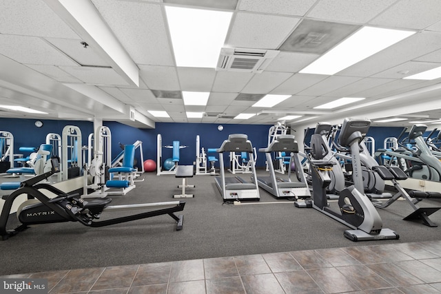 exercise room featuring a paneled ceiling