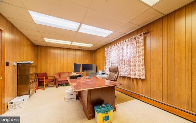 office featuring a paneled ceiling and light carpet