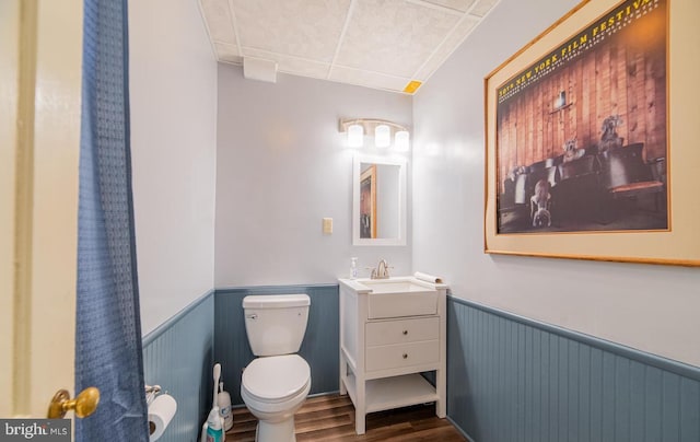 bathroom featuring wood-type flooring, vanity, and toilet