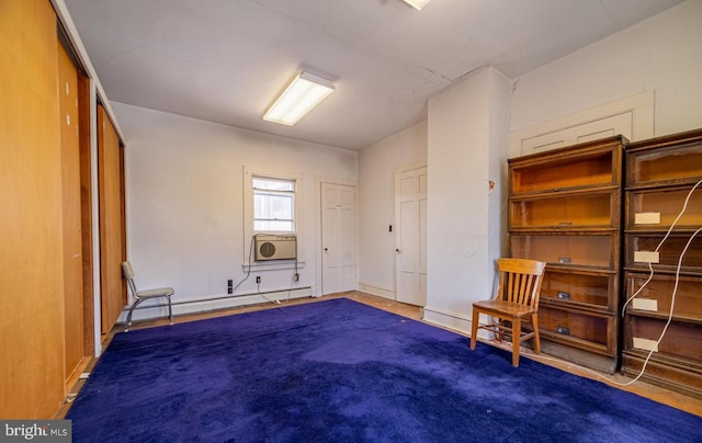 unfurnished bedroom featuring carpet floors, baseboard heating, and cooling unit