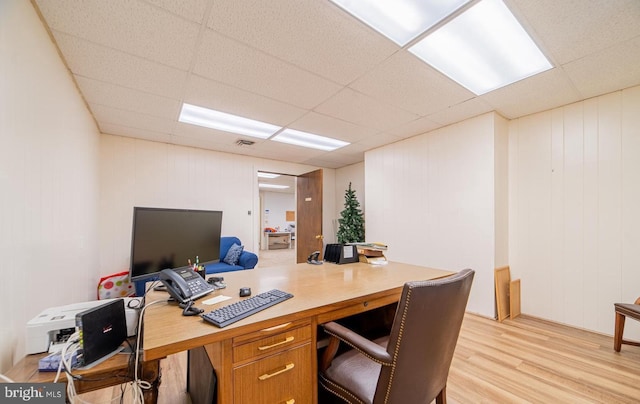 office area with a drop ceiling and light hardwood / wood-style flooring