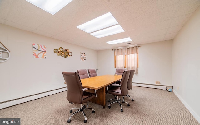 carpeted office featuring a drop ceiling and baseboard heating